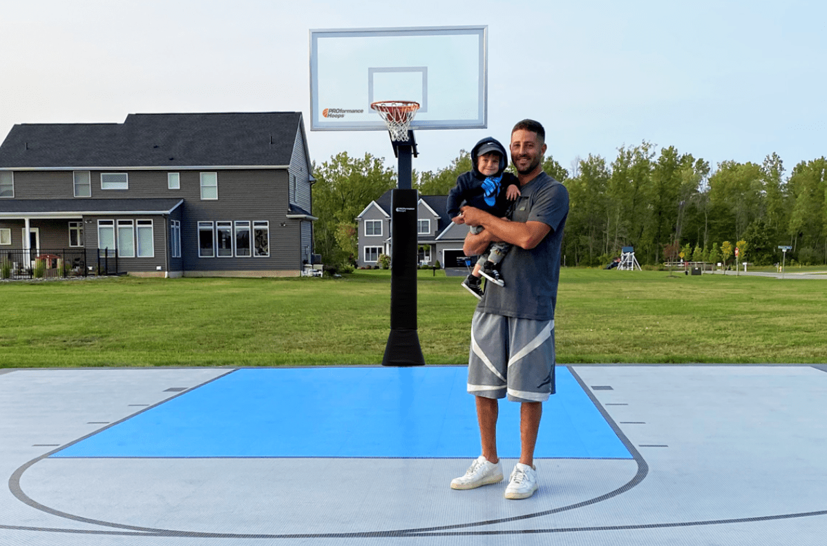 Mother hugging her son in front of a Springfree trampoline