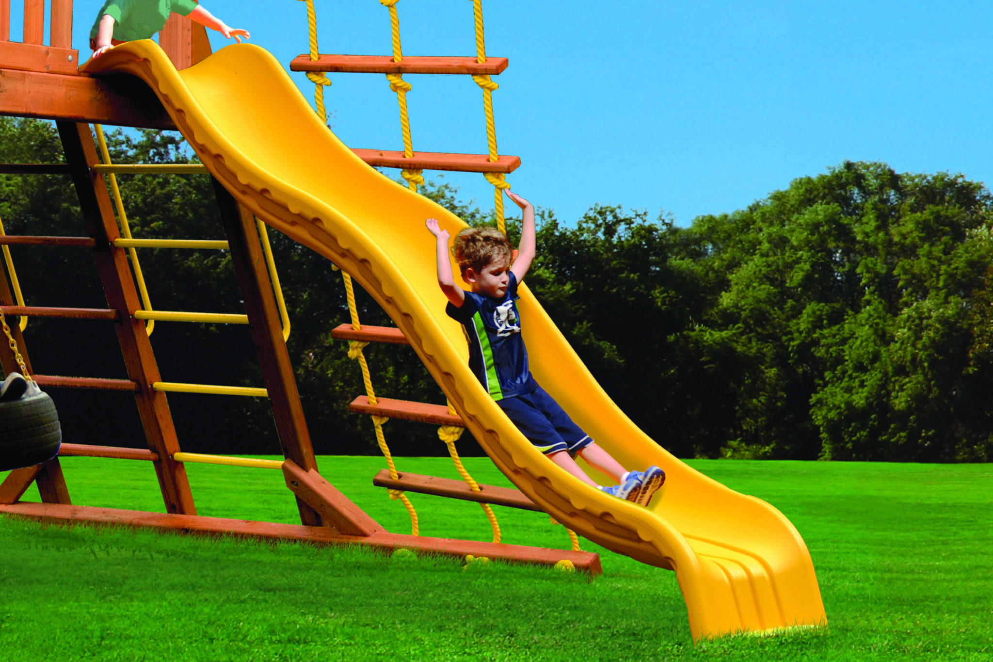 child sliding down playground slide