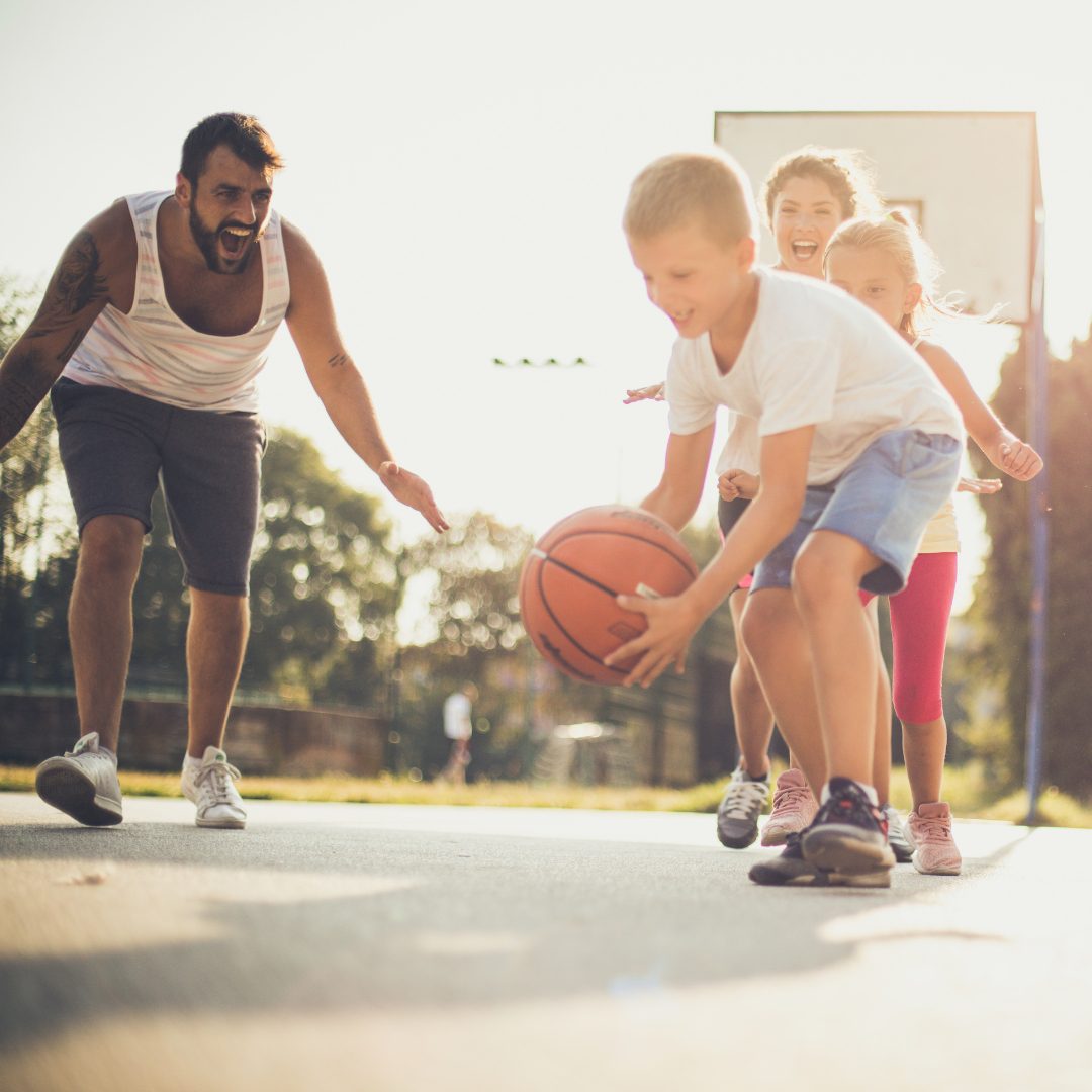 Family playing a fun game of basketball