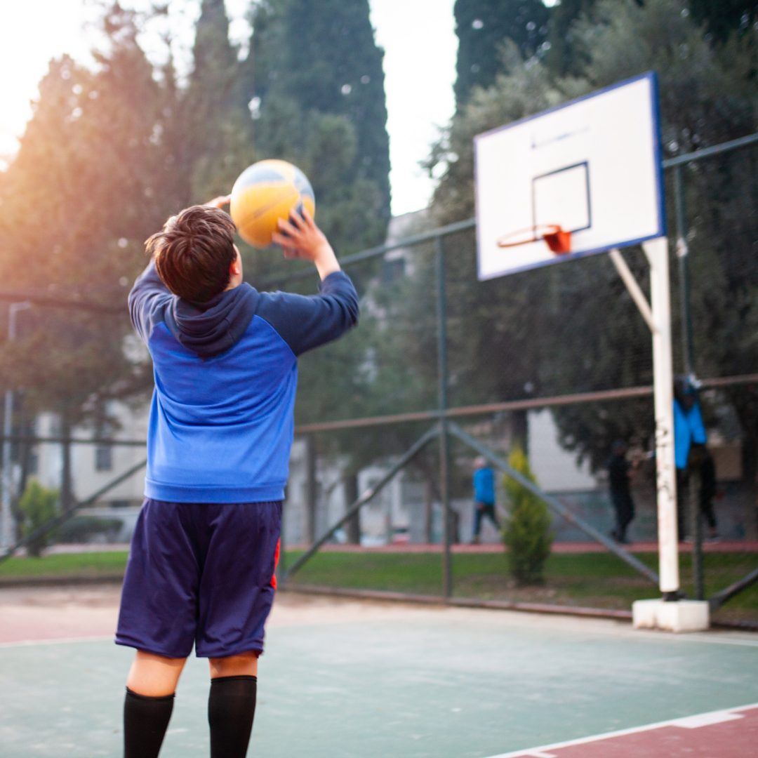 Young boy shooting a basketball