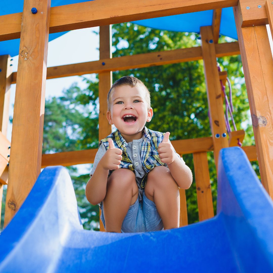 boy at the top of a slide