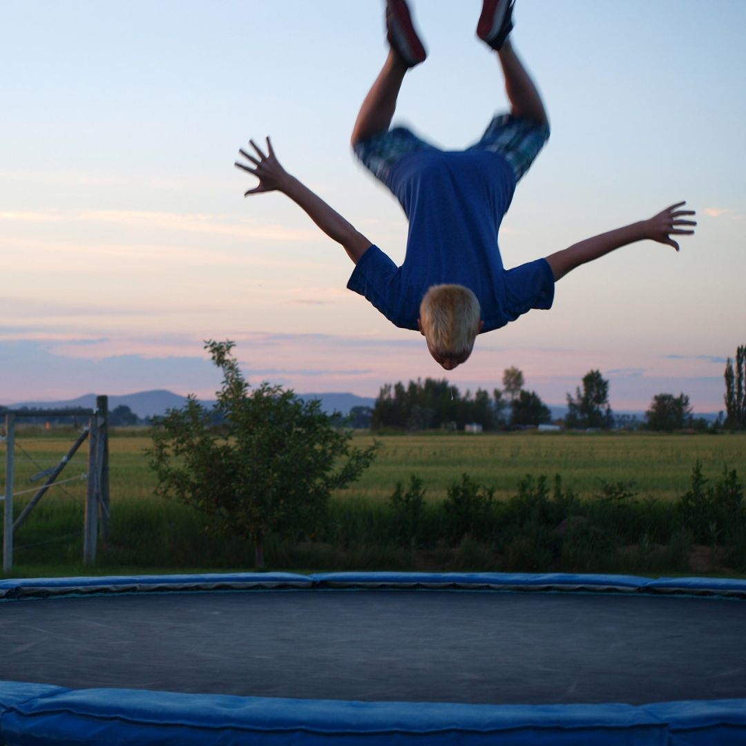 kid flipping on trampoline
