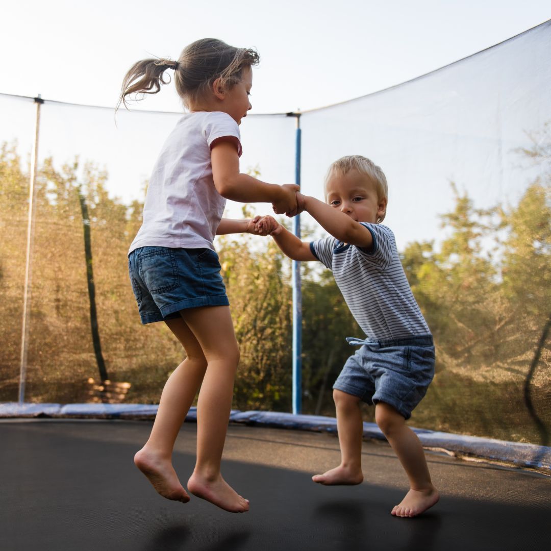 siblings bonding on trampoline