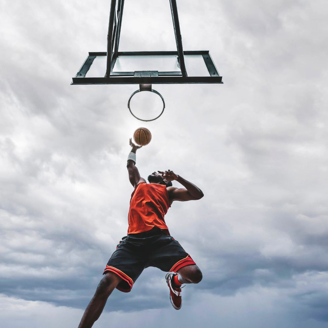man dunking basketball