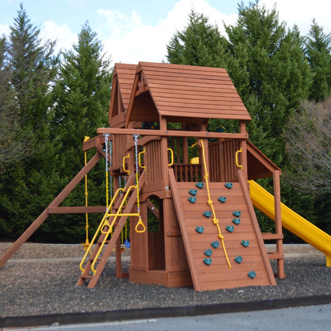 Giant play system with climbing wall