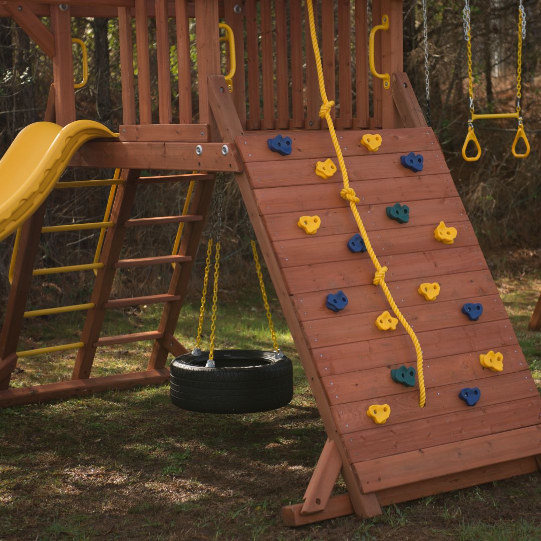 playset with rock climbing wall and tire swing