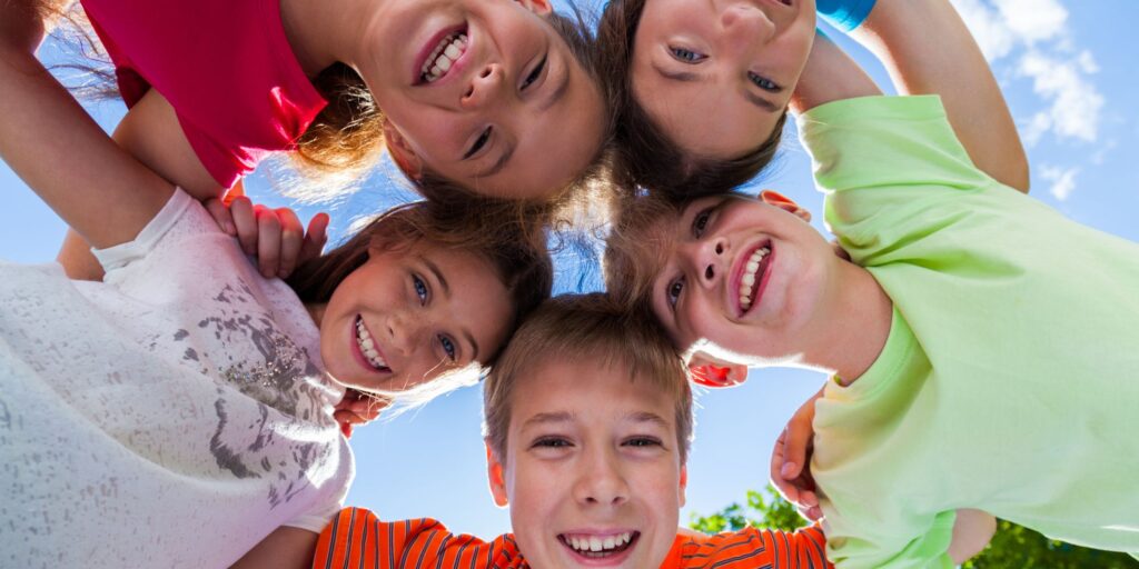 group of kids huddles together in circle