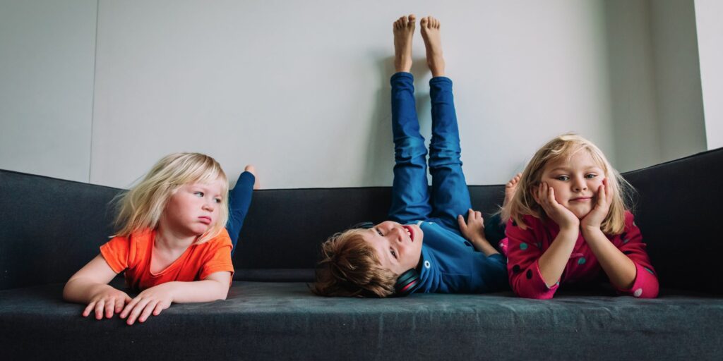 kids lay on couch 