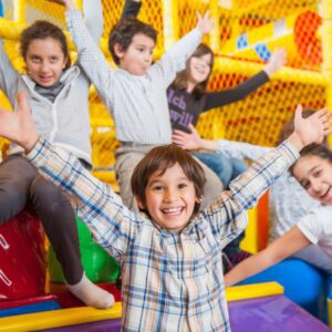 kids throw hands up in excitement on playground