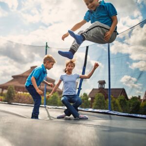 3 kids jump on trampoline 